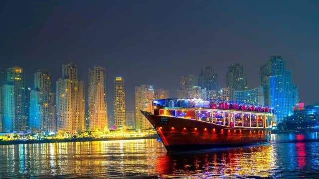 The cruise lit in colour against the night skyline
