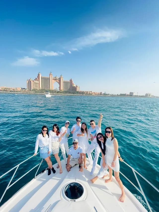 Group on the bow with Atlantis in the distance