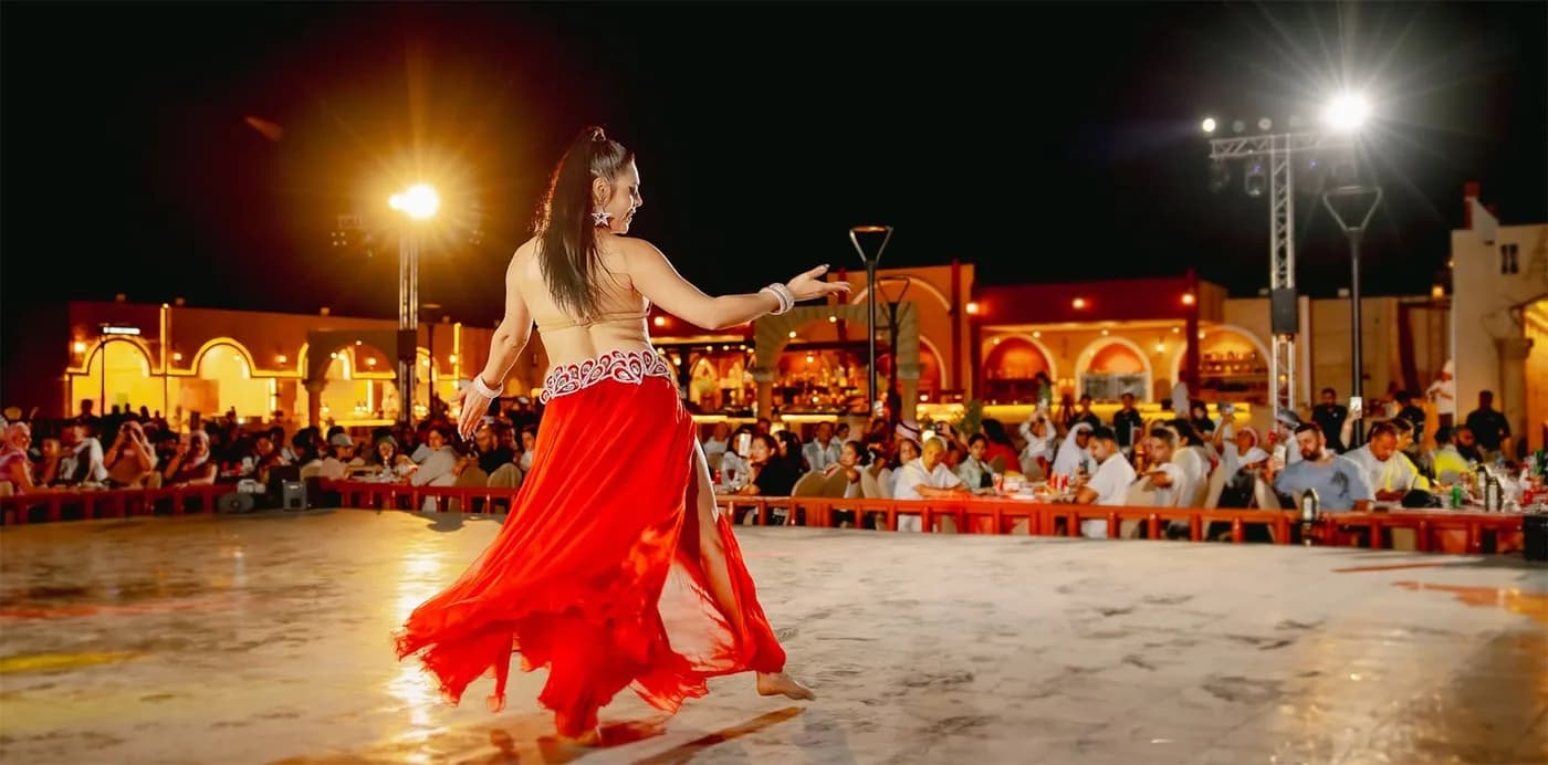 Belly dancer performing at the desert safari camp at night