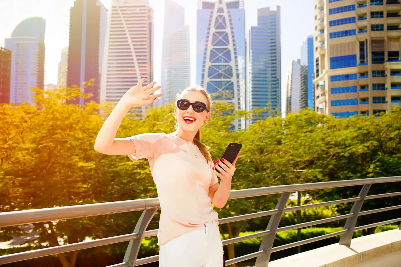 Guest taking photos from a balcony over the Dubai skyline