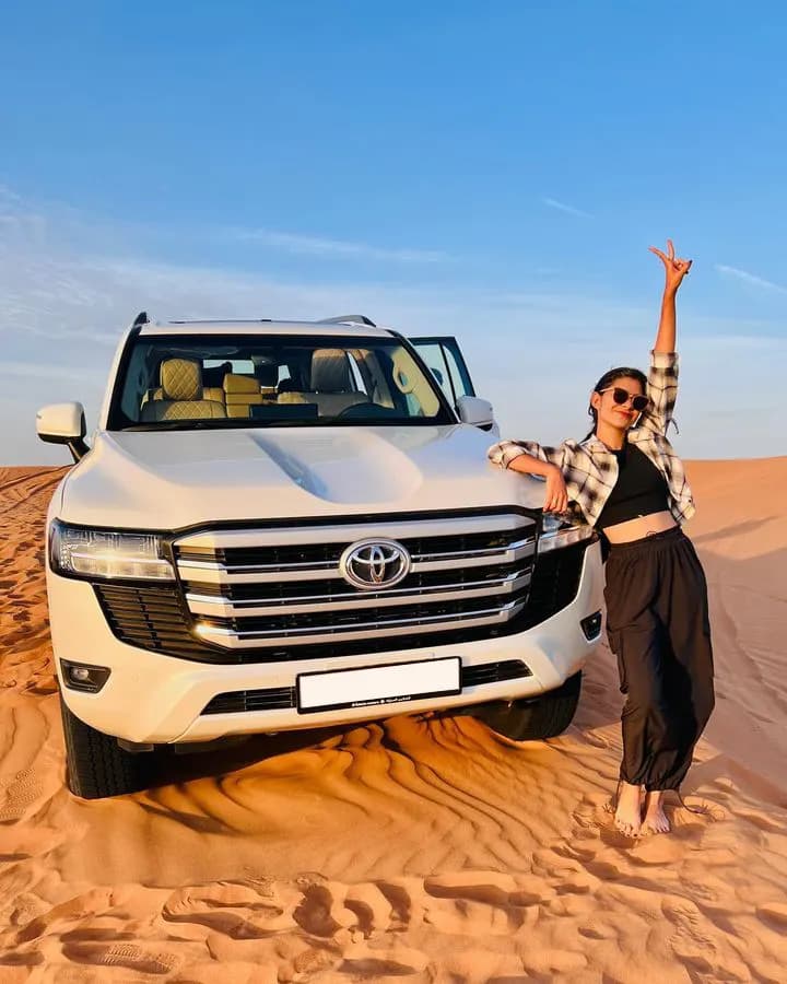Guest celebrating in front of the safari 4x4