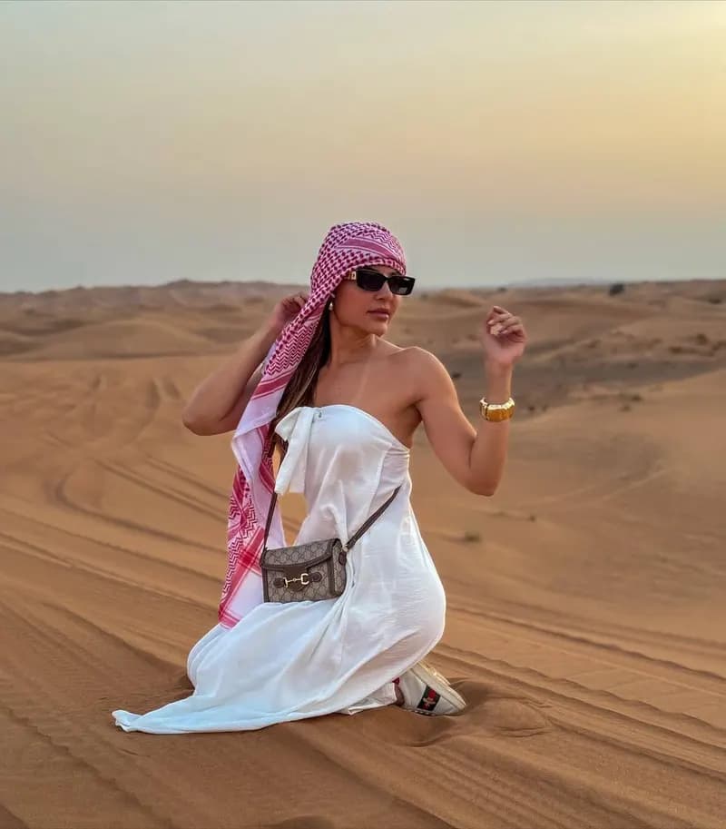 Guest in a headscarf posing on the dunes