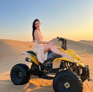 Guest seated on a yellow quad bike