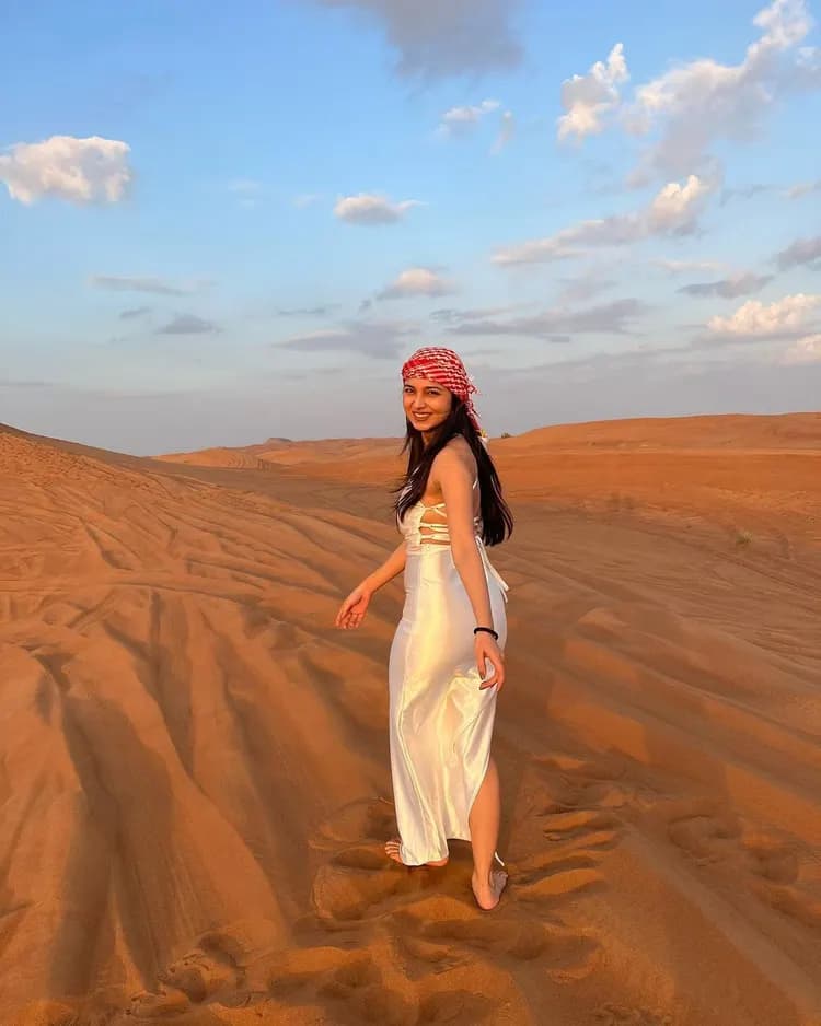 Guest walking on the dunes at golden hour