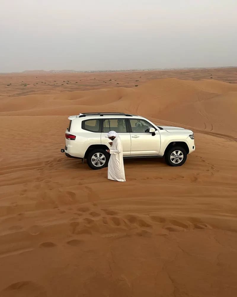 Private white 4x4 parked on the dunes