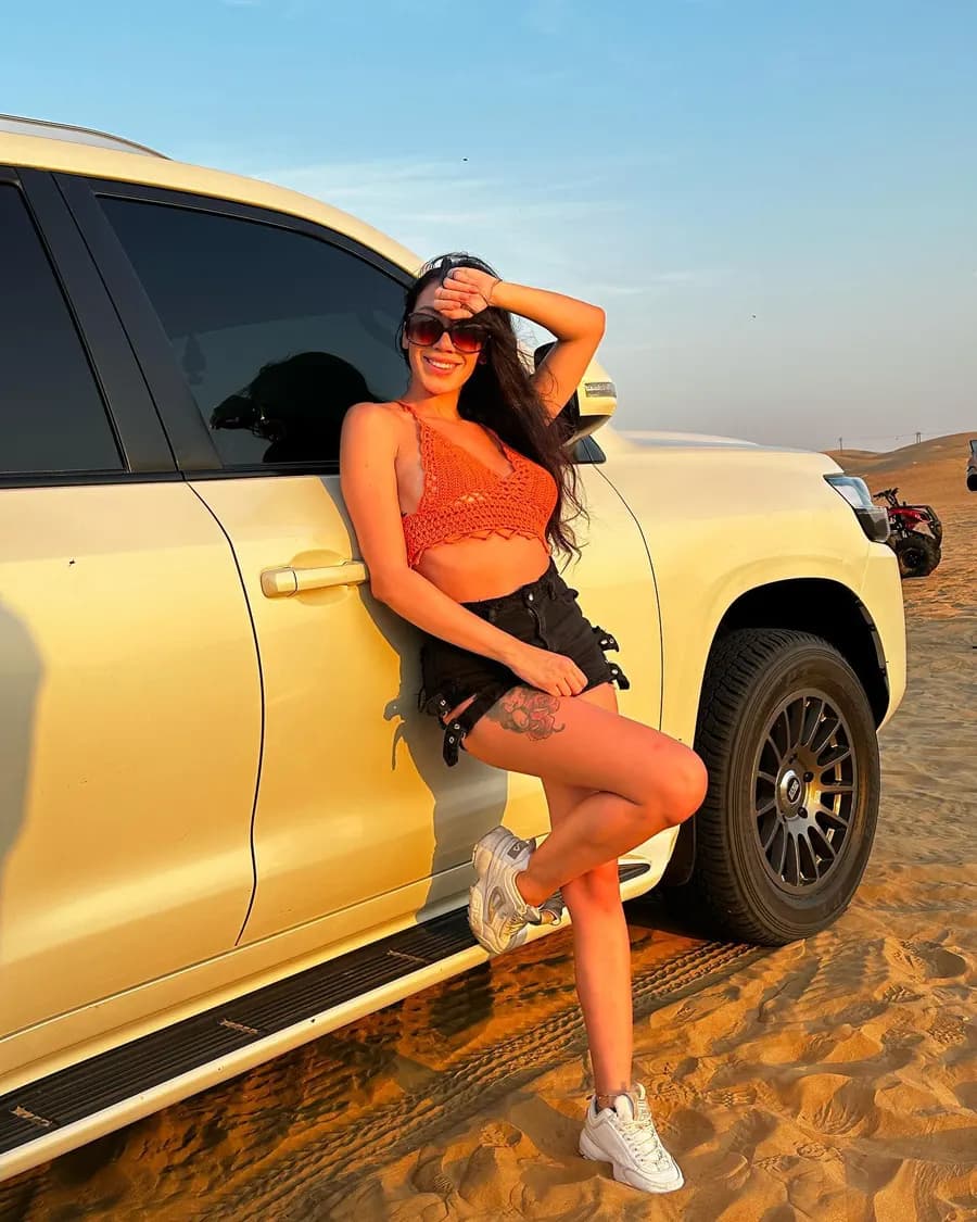 Guest leaning on the private 4x4 in the desert