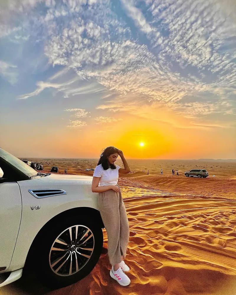 Guest leaning on the private 4x4 at sunset