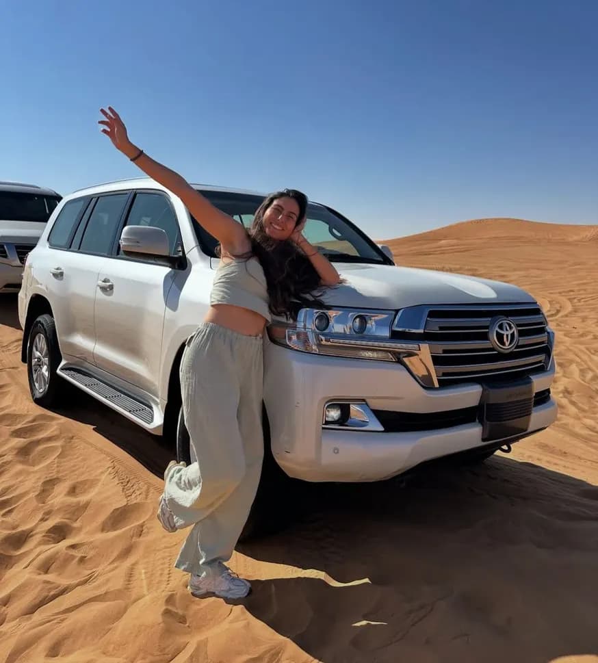 Guest waving from the private 4x4 in the desert
