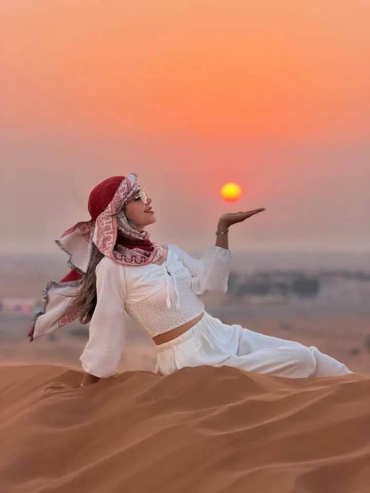 Guest holding the setting sun on the dunes