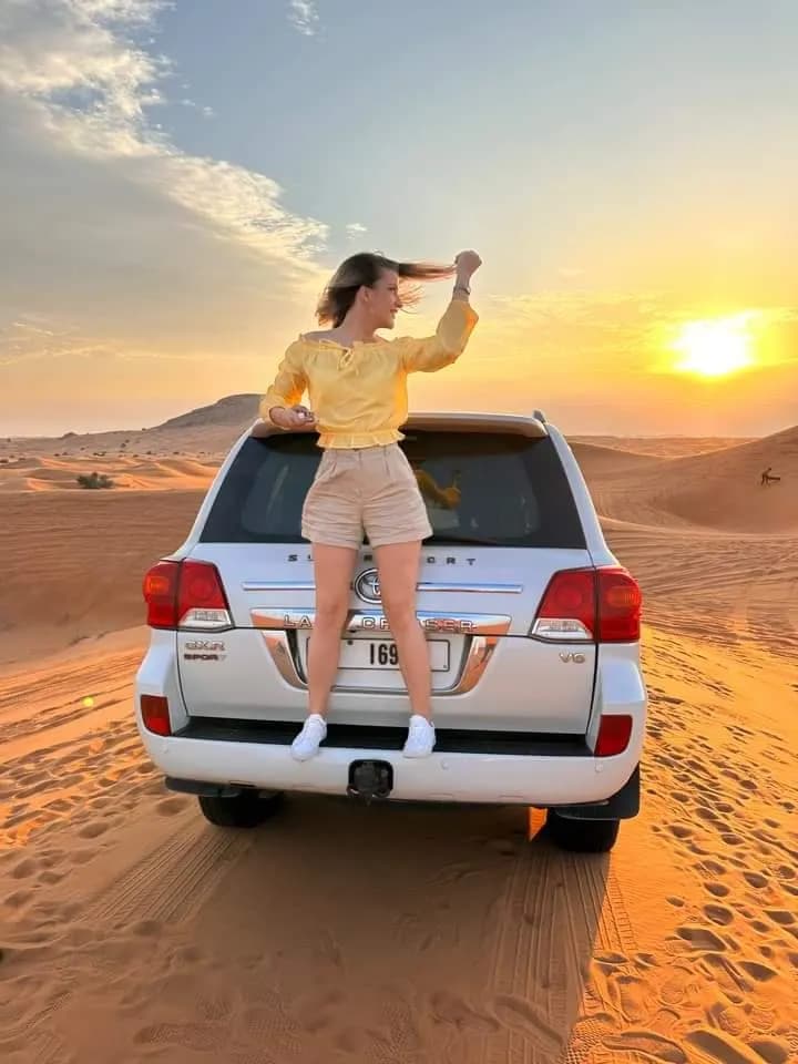 Guest sitting on the back of the private 4x4 at sunset