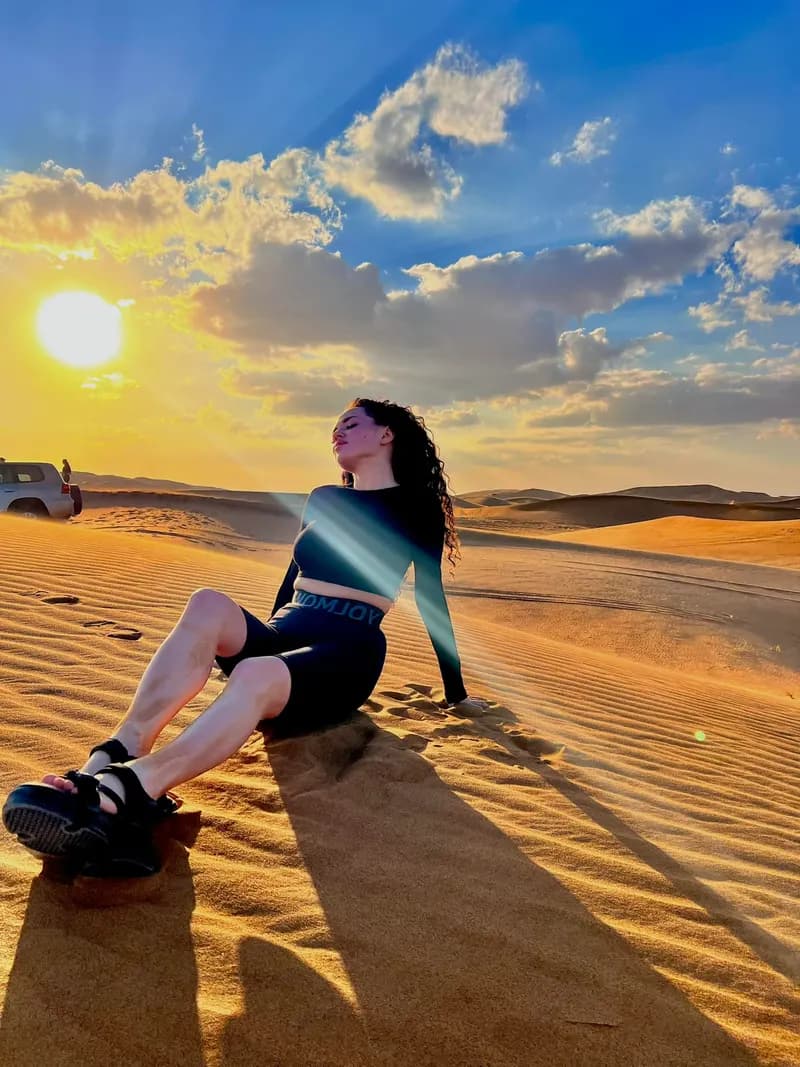 Guest relaxing on the dunes under a blue sky