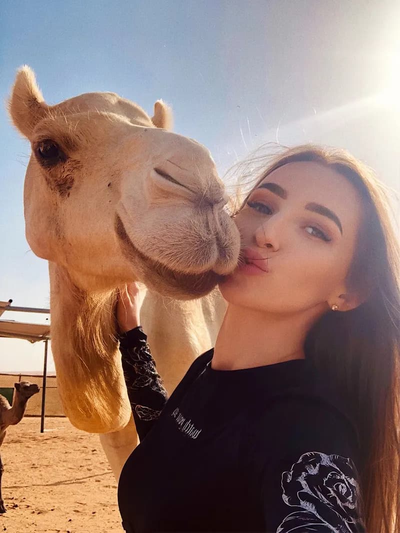 Guest taking a selfie with a camel