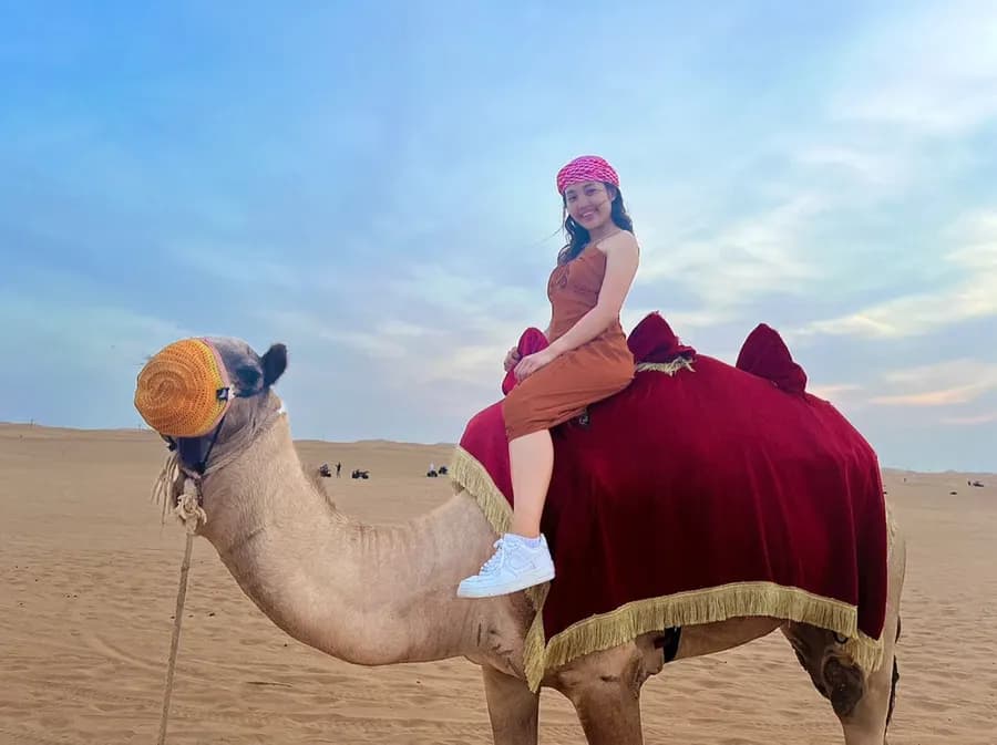 Guest enjoying a camel ride in the desert