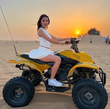 Guest on a yellow quad bike in the desert