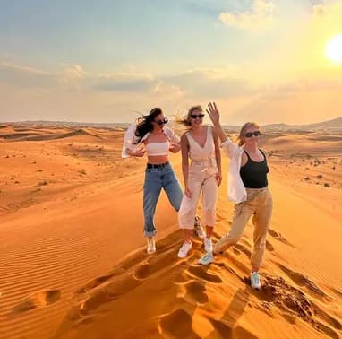 Friends celebrating on the desert dunes