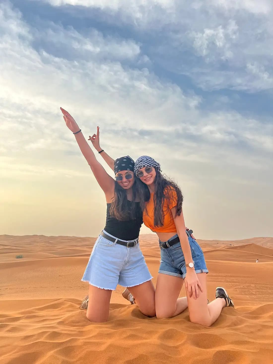 Friends celebrating on the dunes at sunrise