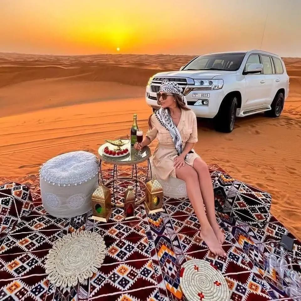 Sunrise picnic setup beside the 4x4 in the desert