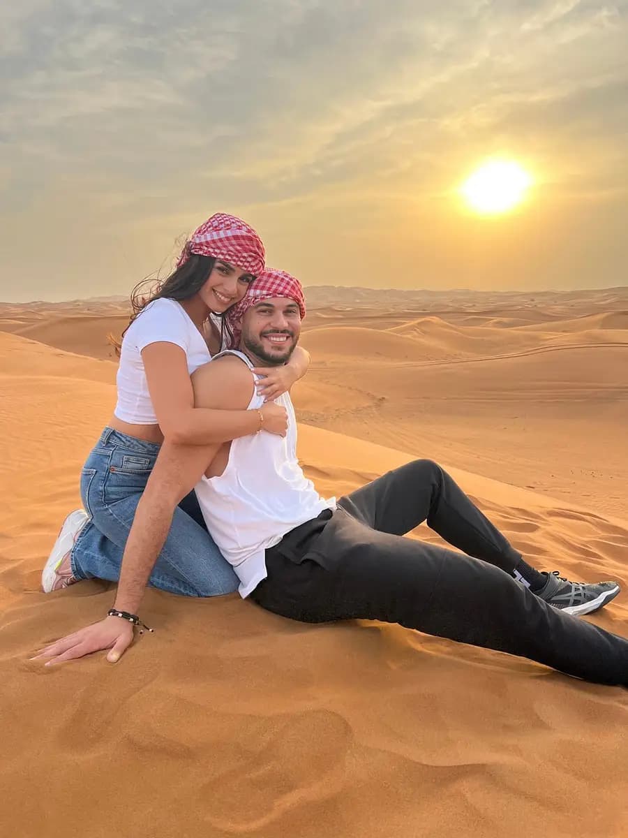 Couple sitting on the dunes in the morning light