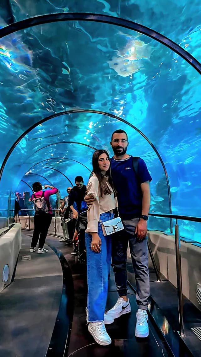 Couple walking through the aquarium tunnel