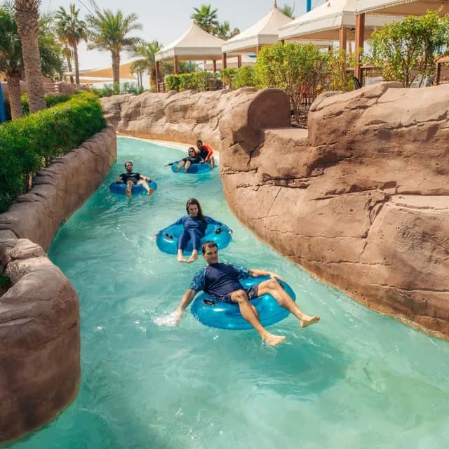 Guest floating along the lazy river between the rocks