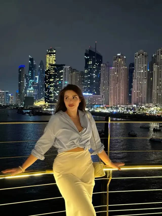 Guest with the Dubai Marina skyline at night