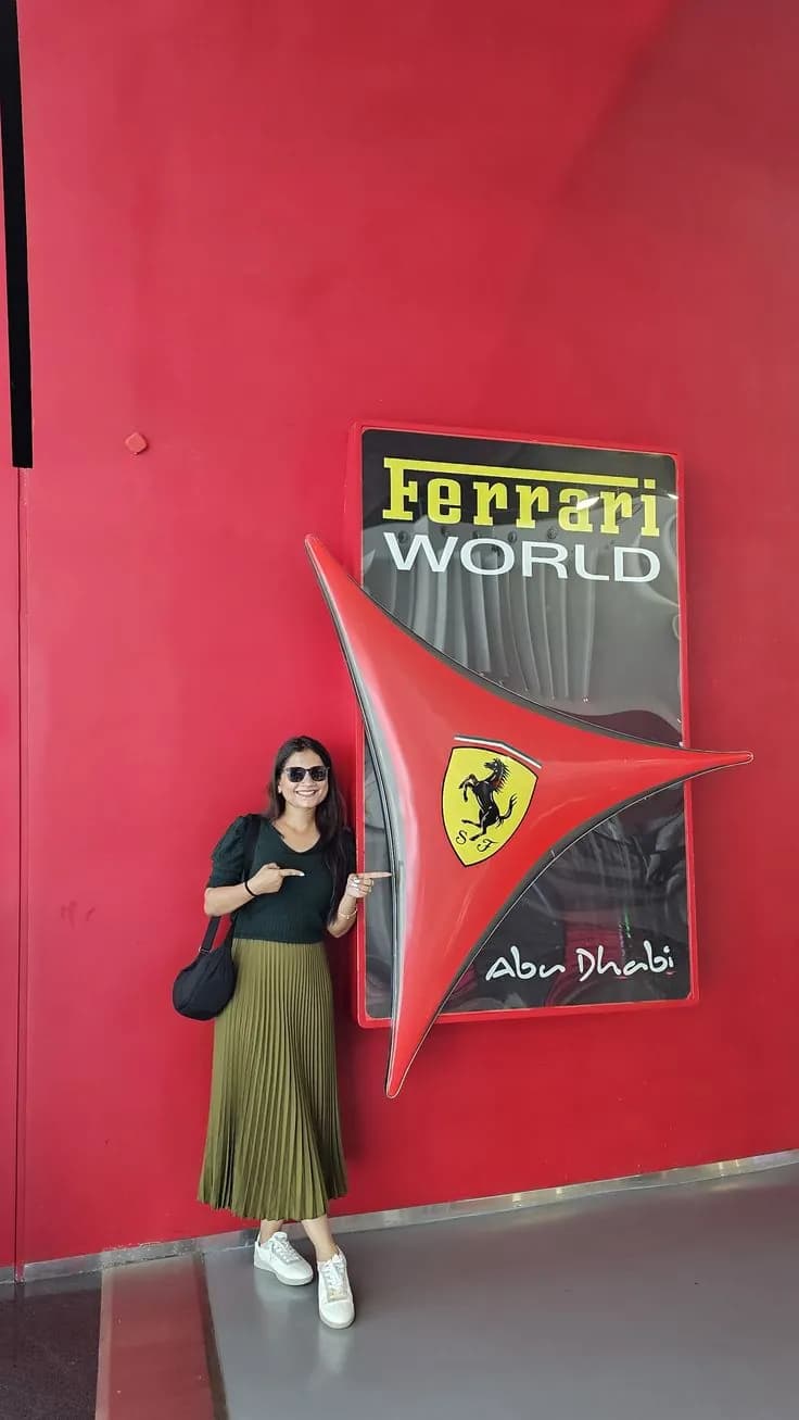 Guest pointing at the Ferrari World sign