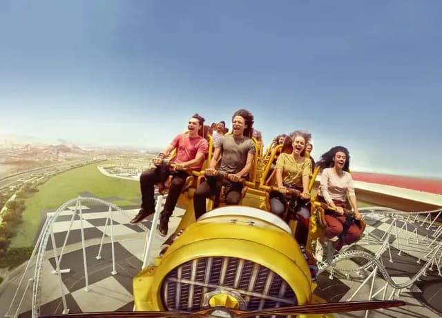 Riders on the yellow coaster train