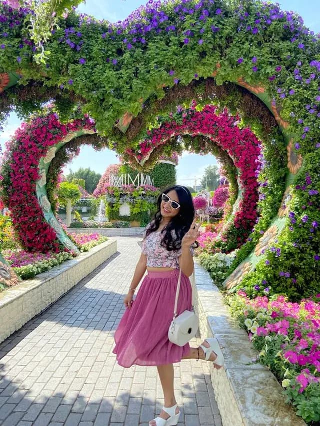 Visitor walking through the heart-shaped flower arches
