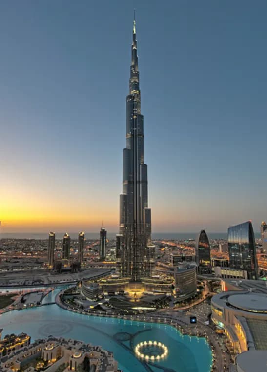 Burj Khalifa towering over downtown Dubai at sunset
