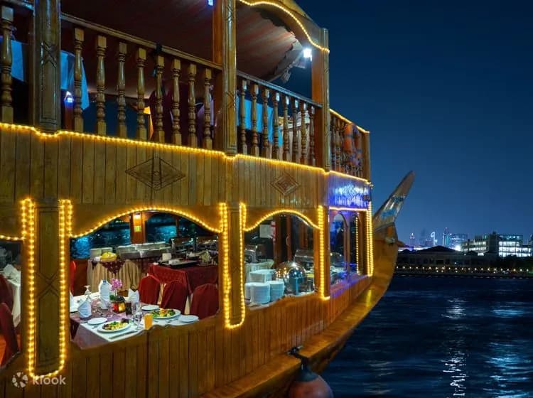 Tables laid along the dhow's illuminated deck