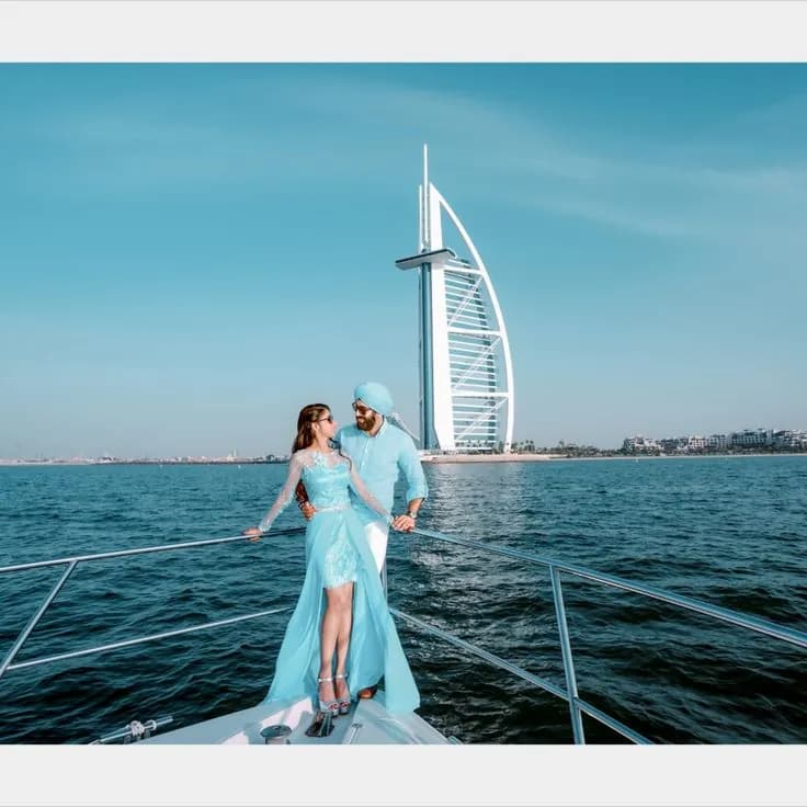 Couple on the yacht bow with the Burj Al Arab behind
